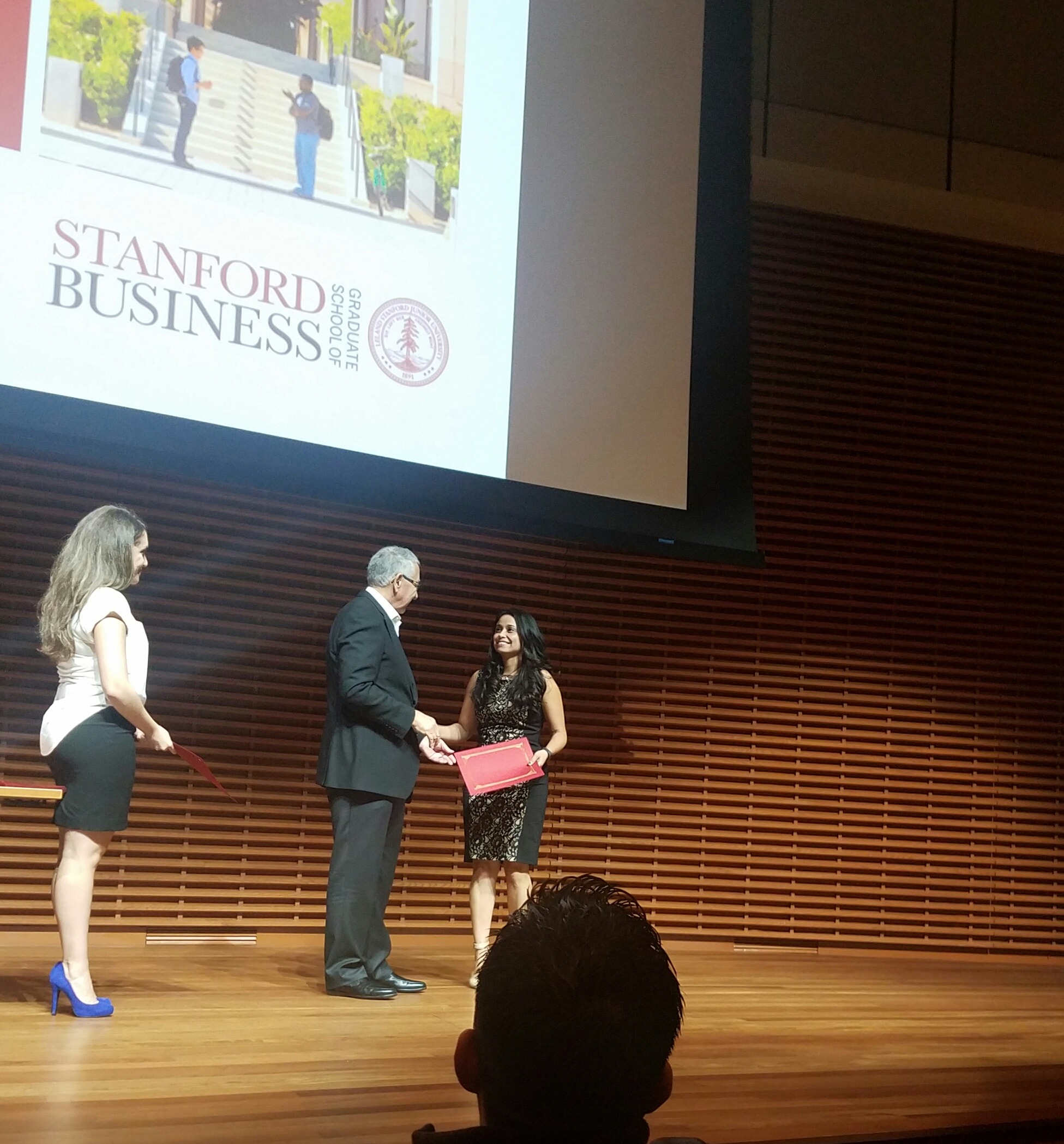 Latina Technology Leader Natasha Pongonis, receiving a certification of completion from the Stanford Latino Entrepreneur Leaders Program